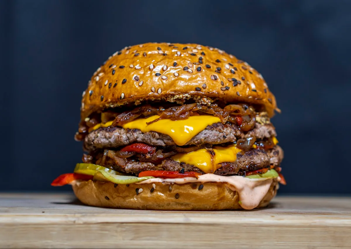 Stacked beef burger with melted cheese