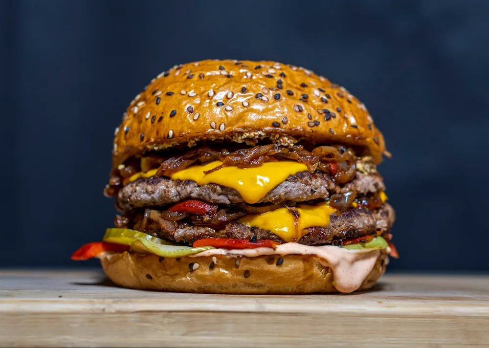 Stacked beef burger with melted cheese