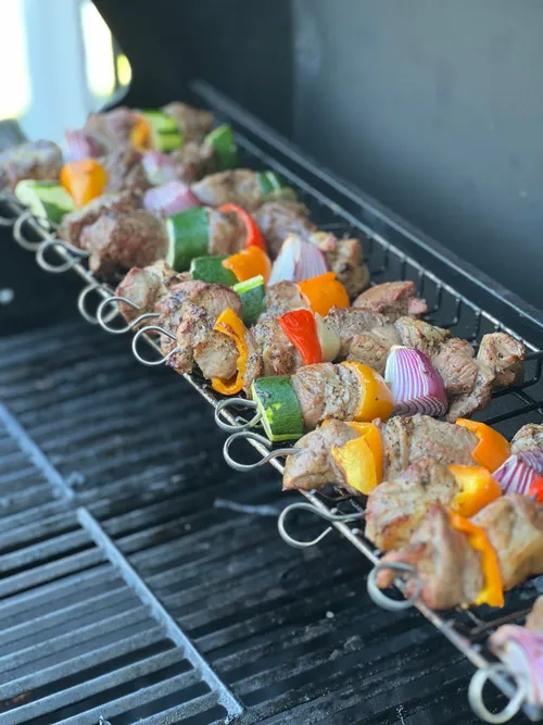 Skewers of marinated meat, peppers and courgette on the grill