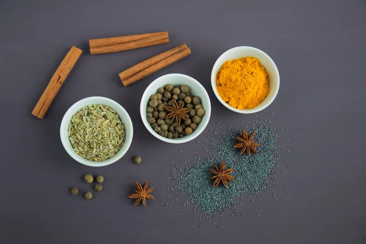 Whole spices used in Middle Eastern and Kurdish cooking — cinnamon, star anise, allspice and turmeric